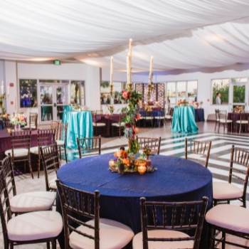 event set up with tables, candles, drapes, and more