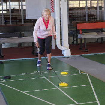 Adult playing shuffleboard