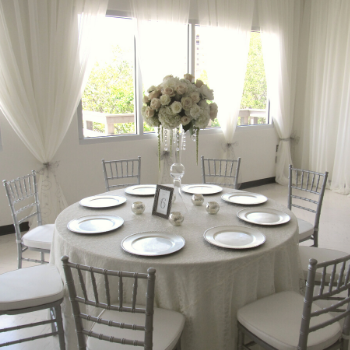 table set with flowers, tablecloth and dinnerware